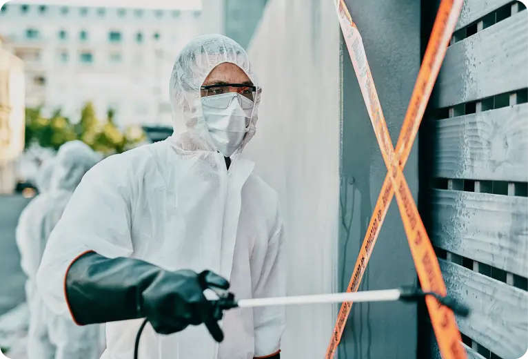 healthcare-worker-covid-pandemic-sanitizing-cleaning-area-with-disinfectant-barrier-caution-tape-face-mask-emergency-medical-person-hazmat-suit-working-coronavirus-crisis